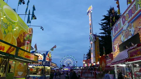 Night shot of people having fun at the West Coast Amusements Carnival Stock Footage 157792591