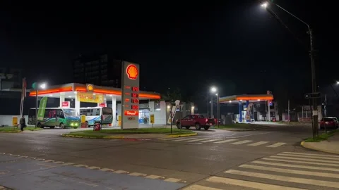Night shot of Shell gas station showing fuel prices in Valdivia Chile with slow Stock Footage 336639368