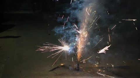 Night shot showing firework with sparks flying and multiple small explosions all Stock Footage 310037790