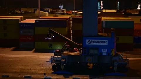 Night shot of tele handler  tractor driving through containers of a port Stock Footage 223735573