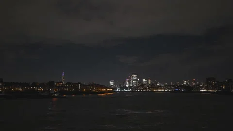 A night shot of Thames river and London city in the distance. Stock Footage 256586993