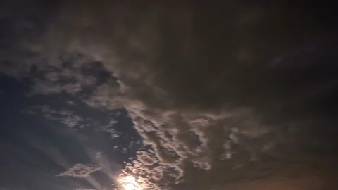 Night sky with algal clouds. The moon shines through the clouds at night Video stock 222037500