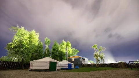 Night sky and clouds with Mongolian yurts in front. 库存影片 338386643