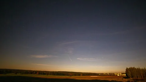 Night sky and comet over fields in moonlight. Stock Footage 290462003
