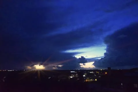 Night sky with clouds and rays of light Foto stock