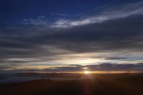 Night sky with clouds and rays of light Stock Photos