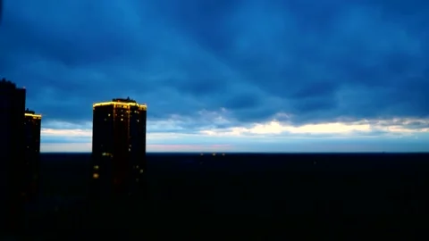Night sky, fast-running clouds against the background of an apartment building 库存影片 131877166