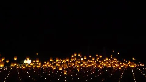 Night sky filled with floating lanterns glowing softly Stock Photos