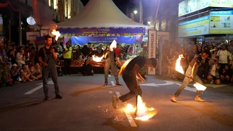 Night sky glows as fire flame show captivates spectators. Vidéo 318265005