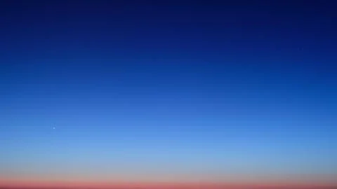 Night sky gradient transition from dark blue to twilight horizon, time lapse. Stock Photos