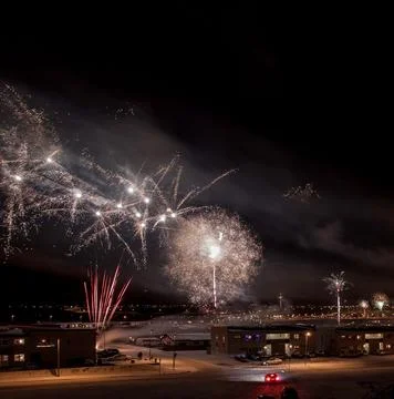 Night sky illuminated by a vibrant array of multicolored fireworks bursting in t 스톡 사진