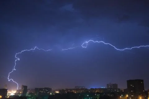 Night sky with lightning over the city Stock Photos