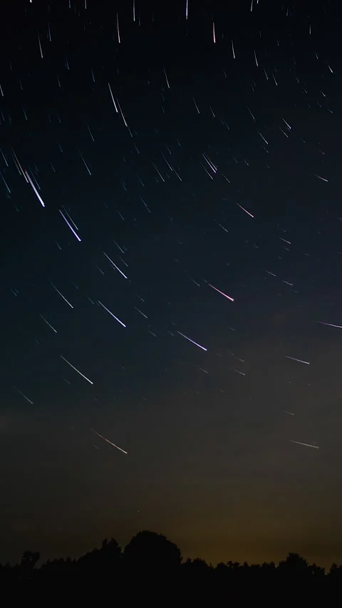 Night sky star trails with comet streaks above horizon Stock Footage 336178930