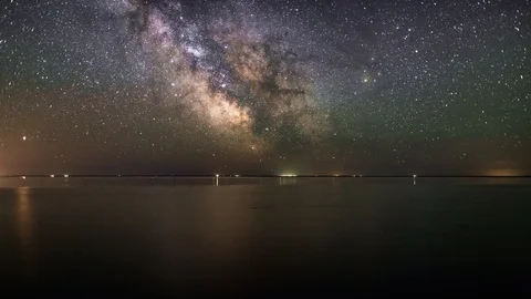 Night sky of stars and Milky way time lapse over the salt lake Elton. Stock Footage 90484553
