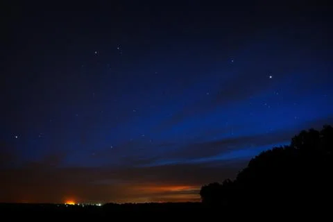 Night sky with stars. A bright sunset with clouds. Cosmic space above the ear Foto stock