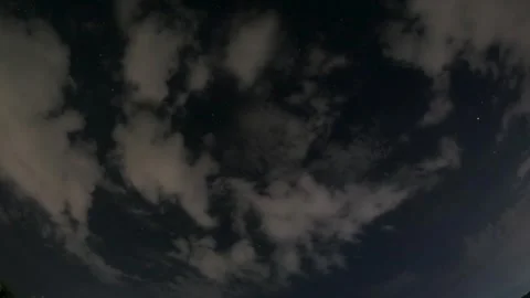 Night Sky Time Lapse with Stars and Passing Clouds over Dark Rural Landscape Stock Footage 325712697