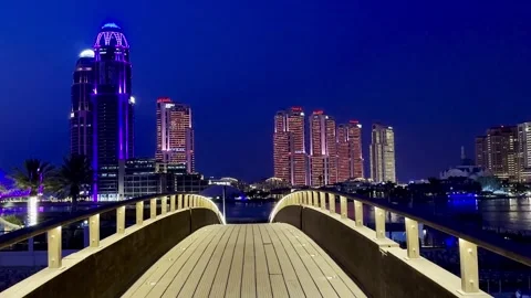 Night skyline of Doha featuring illuminated modern skyscrapers Stock Footage 325901037