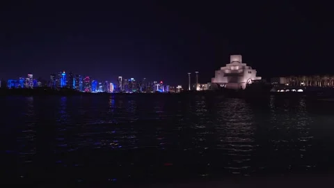 Night skyline glows softly above calm water 스톡 동영상 337763653