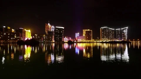 Night Skyline of Macau with reflections. Lisboa -Mandarin Oriental  Wynn Casino Stock Footage 82857428
