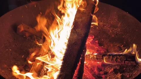 Night slow motion video of a bonfire in an iron fire bowl. Flame of burning. Stock Footage 319478613