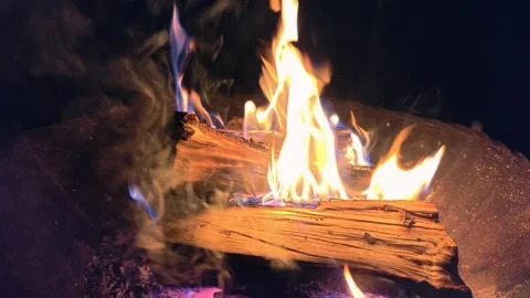 Night slow motion video of a bonfire in an iron fire bowl. Flame of burning. Stock Footage 319478700