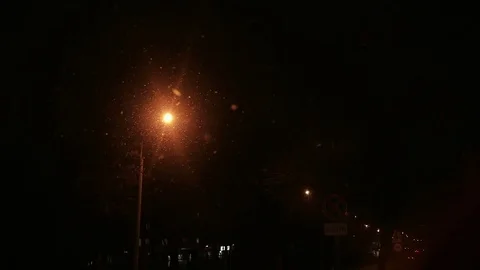 Night snowfall in the city. Full HD video. Light of road lights Stock Footage 82425962