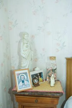 Night stand covered with religious objects and photos Stock Photos