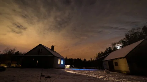 Night starry and cloudy sky over house and snowed backyard. Stock Footage 166958873