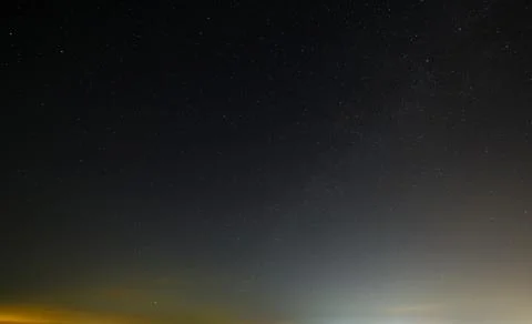Night starry sky with clouds  before dawn. Stock Photos