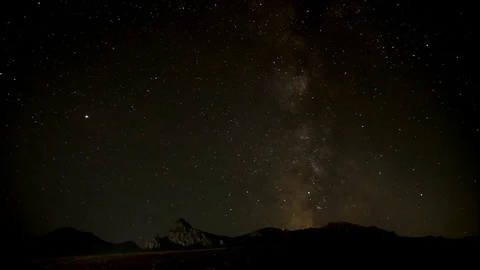 The night starry sky is moving over the mountain range. time lapse Stock-Footage 97060482