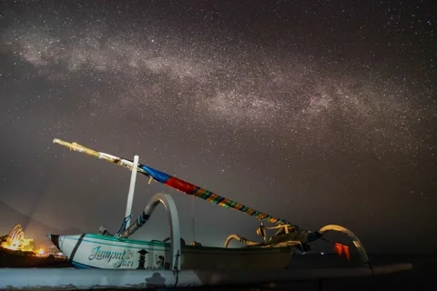 Night stars sky time lapse milky way galaxy fisherman boat at beach Stock Footage 143815893