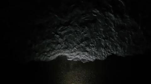 Night surf in a spot of light. View from above Stock Footage 151135772