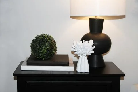 On night table are decorative objects with black lamp Foto stock