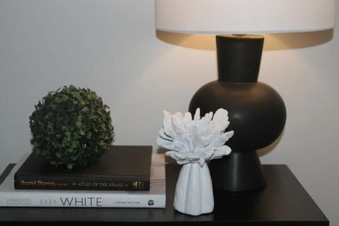 On night table are decorative objects with black lamp Stock Photos