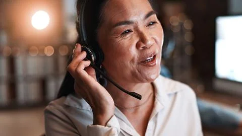 Night, tech support and asian woman in office, headset for communication an.. Stock Photos