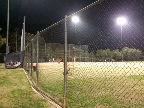 Night time baseball game at playing field outdoor Stock Photos