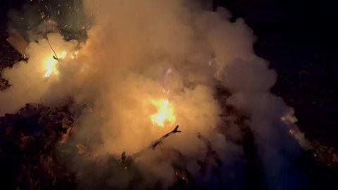 Night time bond fire with smoke Handheld Stock Footage 257285194