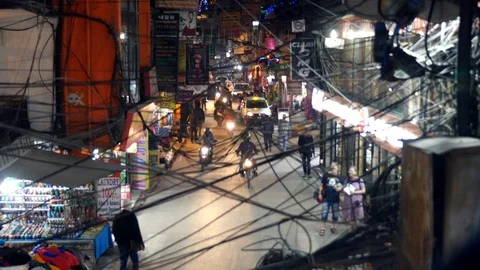 Night time busy moped intersection Kathmandu Nepal electrical lines crossing Stock Footage 119350070