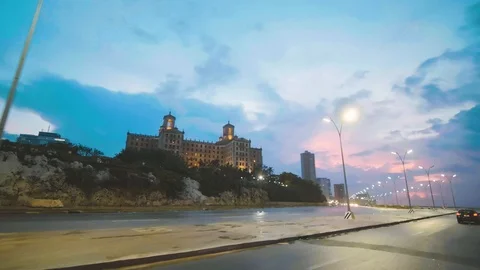 Night time driving shot of a large hotel on the coast in Havana Cuba Stock Footage 88763814