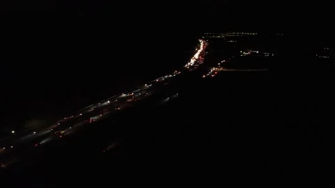 Night time freeway flyaway with side pan lots of traffic Stock Footage 165569434