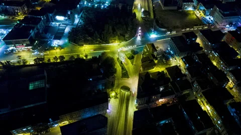 Night Time Hyperlapse In A Busy City. Aerial Drone rotating at intersection Stock Footage