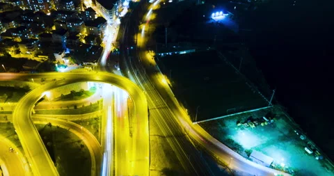 Night Time Hyperlapse In A Busy City. Bridge and road. Aerial Drone Shots. Vídeo Stock 153053085