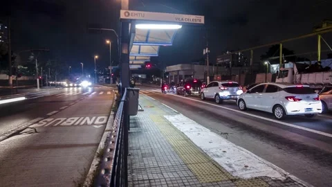 Night time lapse of bus stop on  bus rapid transit corridor, Video stock 154014464