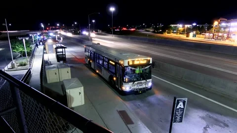 Night Time-Lapse of Busy Bus Depot with Light Trails and Motion Blur Stock Footage 160160932