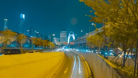 Night time lapse of busy traffic entering a tunnel in Guangzhou city center Video stock 342272810