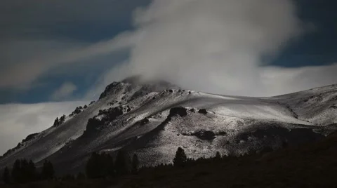 Night time lapse of clouds and stars passing snowed mountain landscape nature  Stock Footage 65221963
