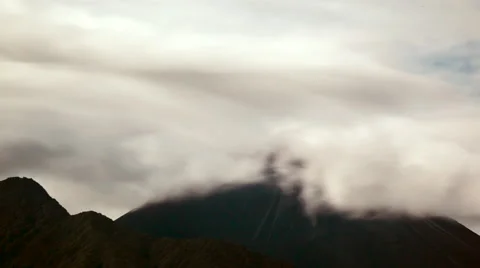 Night Time-lapse of clouds blowing over Reventador Volcano and an eruption Stock Footage 62472743