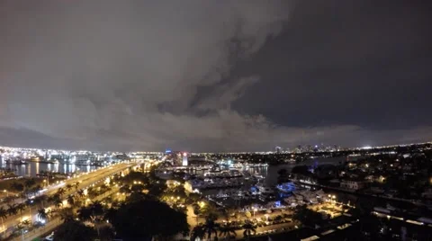 Night time lapse of fast moving boats, cars, people and clouds in port city 库存影片 67089720