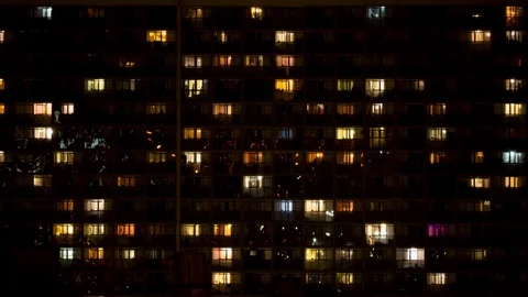 Night time lapse of light in the windows of a multistory building Stockbeeldmateriaal 125460909