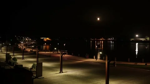 Night time-lapse - the moon is full on the waterfront of the city of A Coruna. Stock Footage 236938045